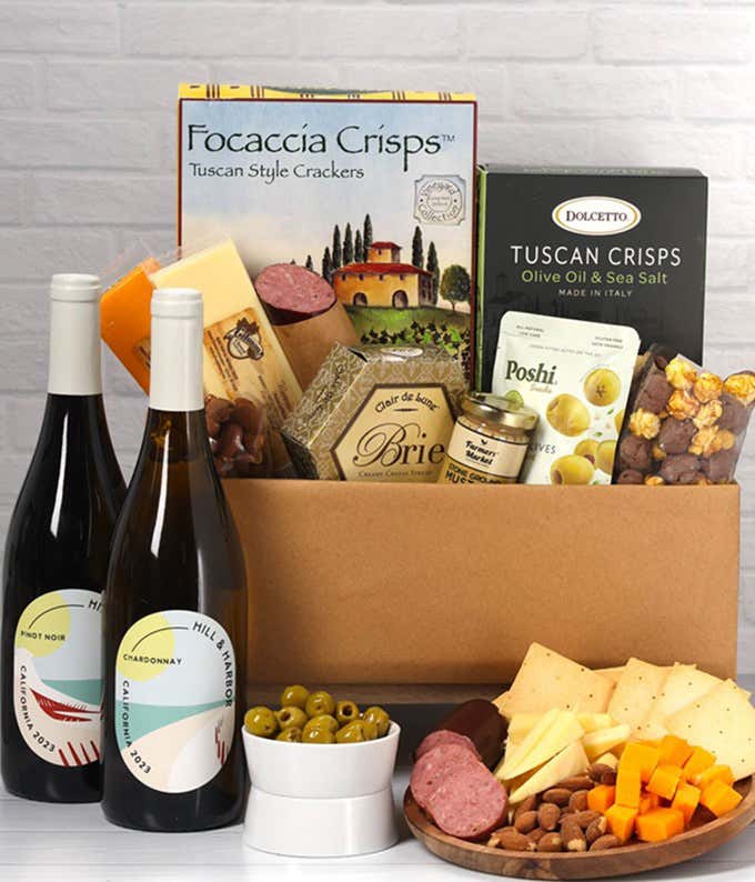 An abundant gift box filled with two bottles of California wine - red & white, assorted crackers, three cheeses, summer sausage, and snacks to make an amazing charcuterie spread. 