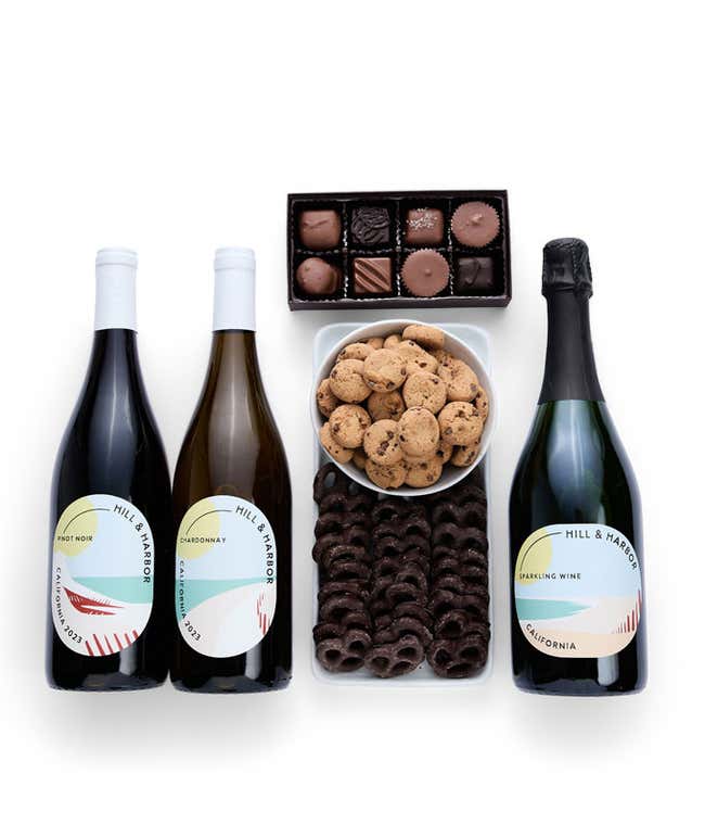 A gift set with three bottles of Hill &amp; Harbor wine (Pinot Noir, Chardonnay, and sparkling wine), a box of assorted chocolates, chocolate-covered pretzels, and a box of mini chocolate chip cookies.